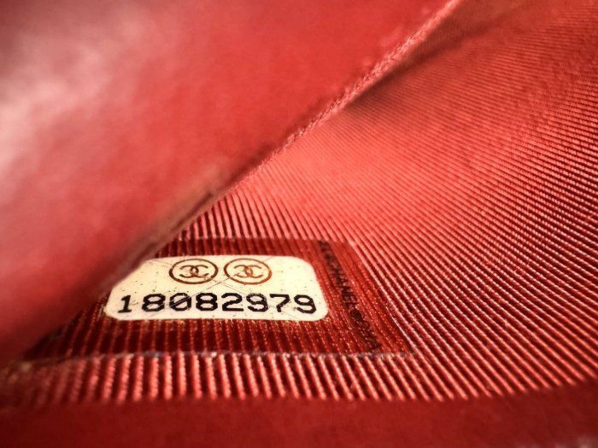 Chanel red quilted leather wallet with CC logo and fabric-lined interior.