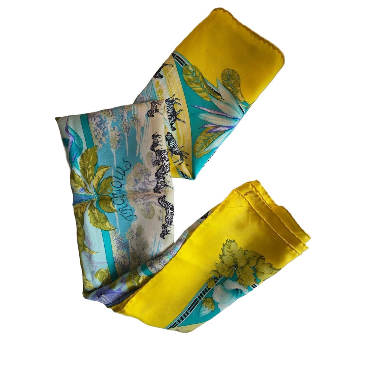 Hermès yellow silk twill shawl featuring tropical animal prints and hand-rolled edges.