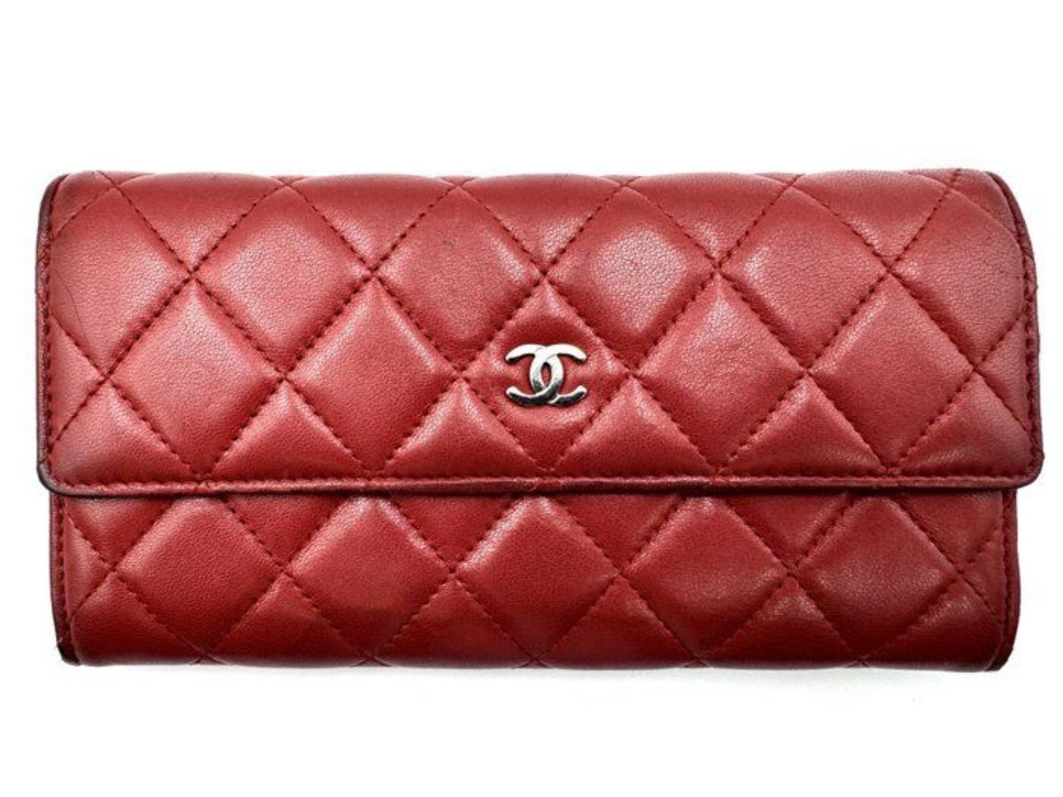 Chanel red quilted leather wallet with CC logo and fabric-lined interior.