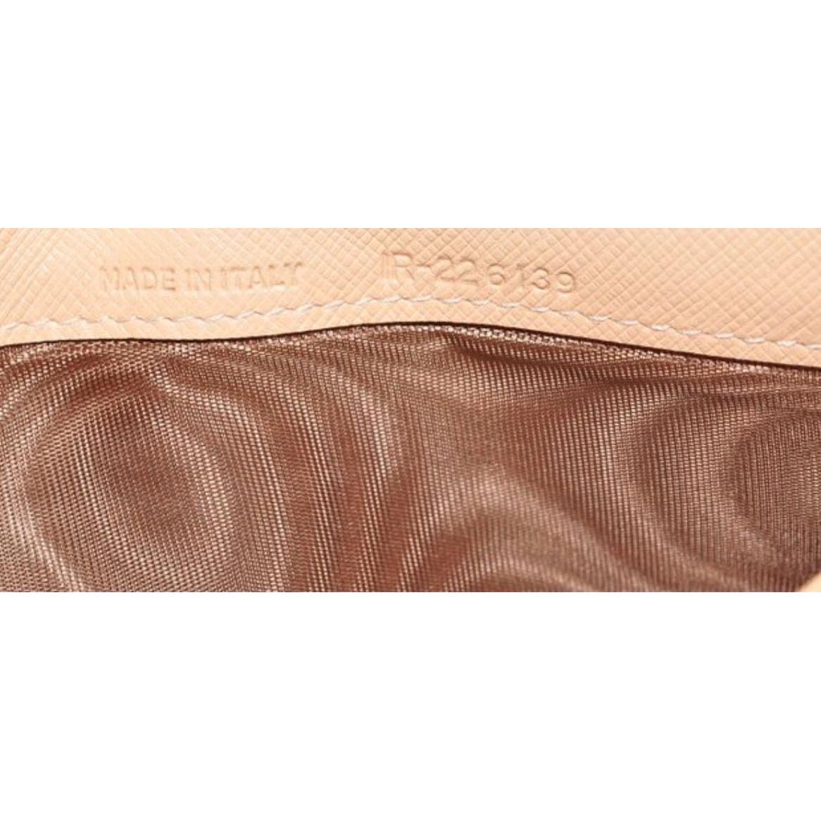 Salvatore Ferragamo burgundy wallet patent leather with iconic bow detail and signature bars.