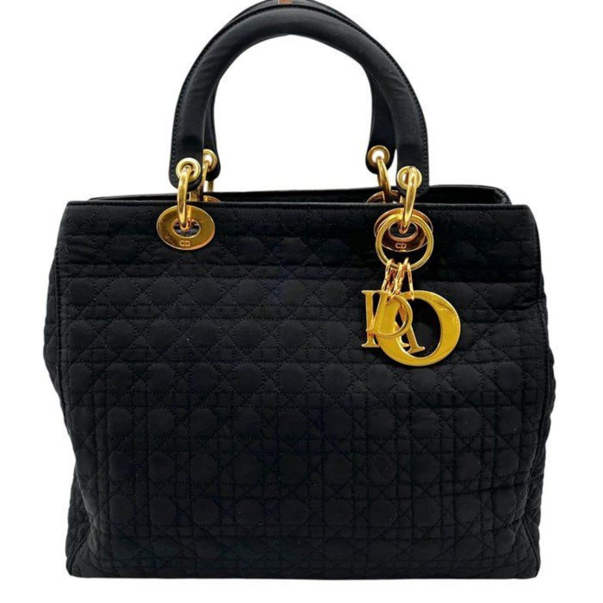 Christian Dior black quilted nylon tote bag with gold hardware and leather trim.