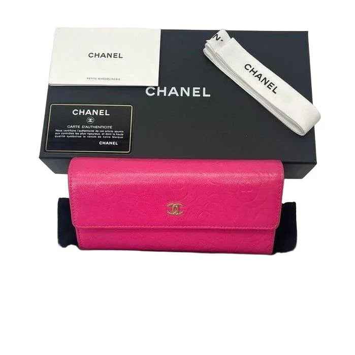 Chanel pink long wallet embossed camellia design in soft lambskin leather with gold hardware.