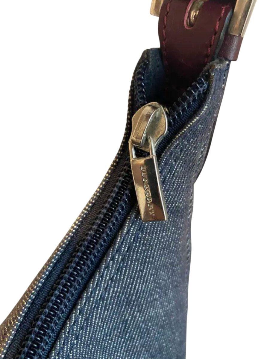 Burberry blue denim shoulder bag with leather trim and polished metal hardware.