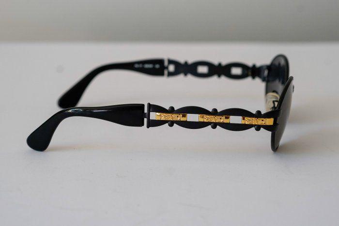 Fendi black and gold sunglasses with logo detail, high-quality plastic and metal frame.