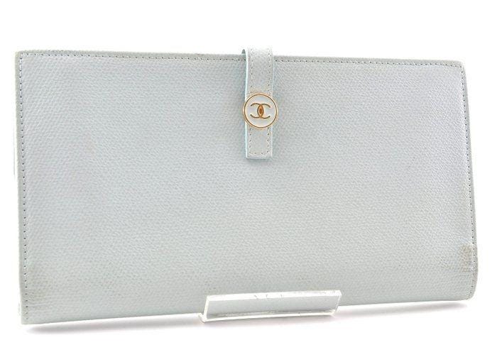 Chanel blue leather wallet with logo detail and minimalist design, featuring light scuffs.