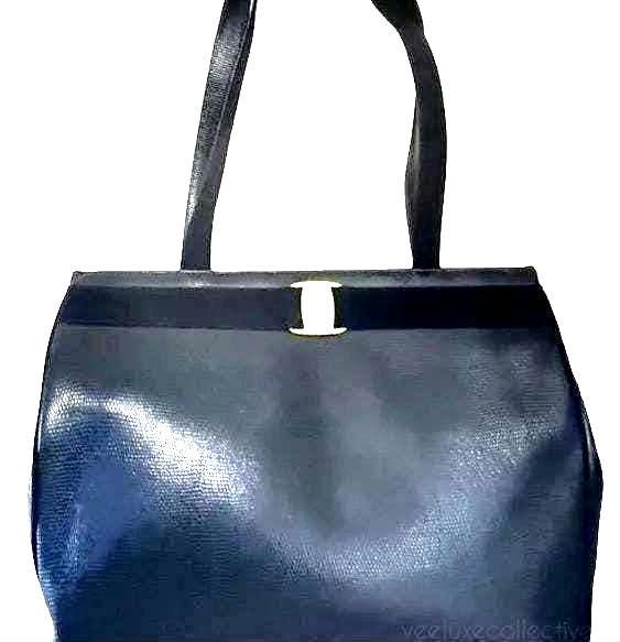 Salvatore Ferragamo blue handbag with gold-tone hardware and signature monogram lining.