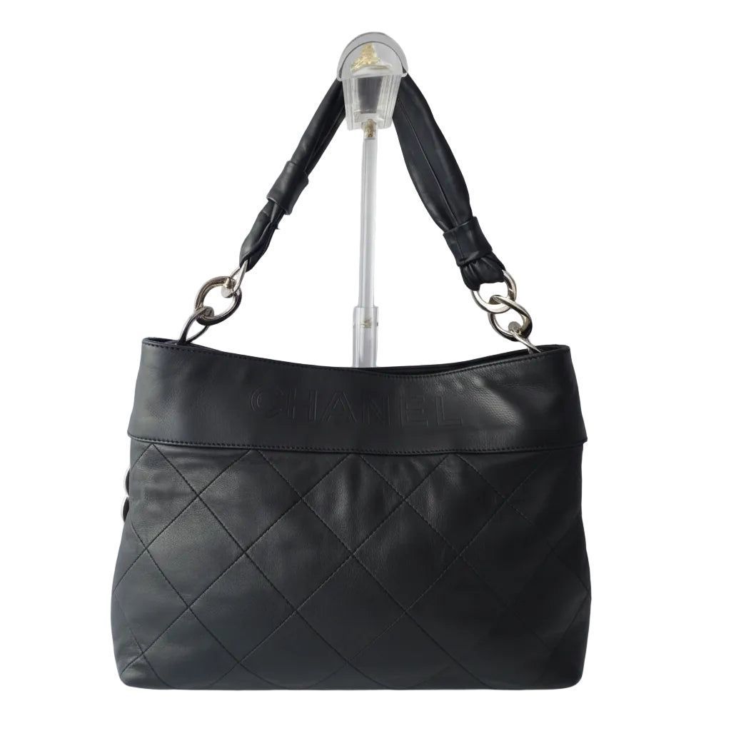 Chanel black Matelassé shoulder tote bag with diamond quilting and gold-tone chain strap.