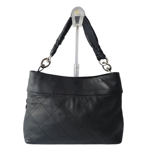 Chanel black Matelassé shoulder tote bag with diamond quilting and gold-tone chain strap.