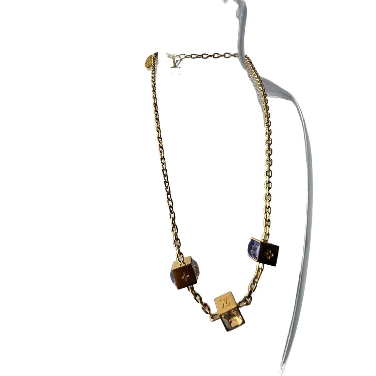Louis Vuitton gold necklace with monogram dice charms and sparkling crystals.