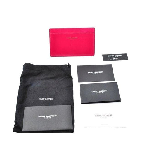 Yves Saint Laurent pink leather card holder with logo detail and smooth finish.