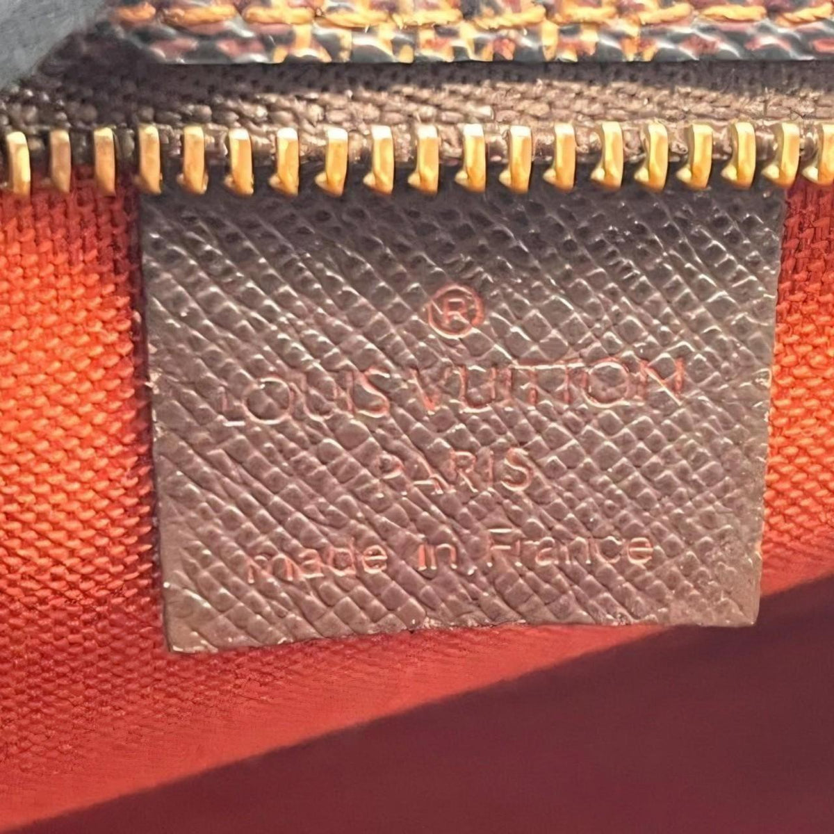 Louis Vuitton Pochette Accessoire brown Damier Ebene canvas handbag with gold hardware.