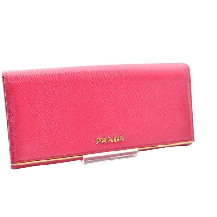 Prada pink leather wallet with logo detail and slim design, perfect for essentials.