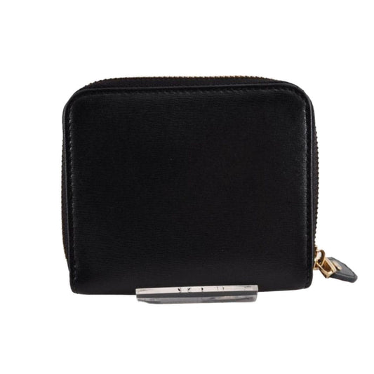 Salvatore Ferragamo cream and pink leather wallet with gold Gancini logo and zip-around design.