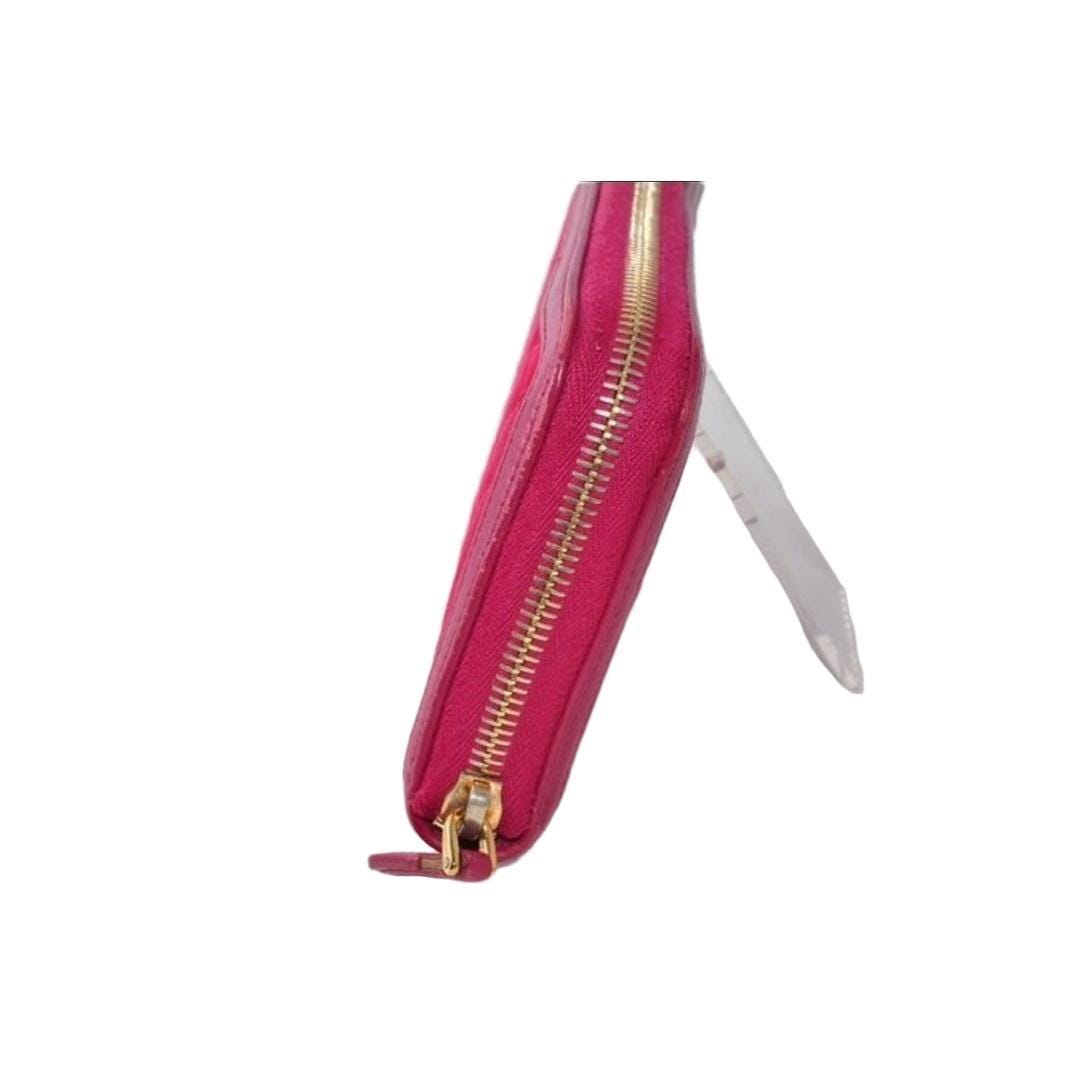 Prada pink nylon and leather zip-around wallet with minimalist design and secure closure.
