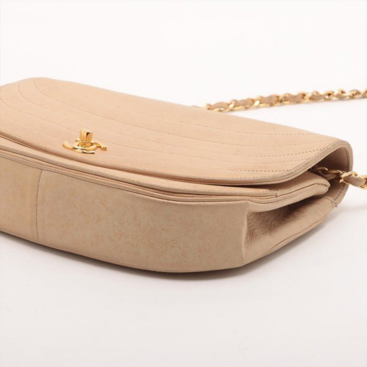 CHANEL beige matelassé leather half moon shoulder bag with gold hardware and classic logo.