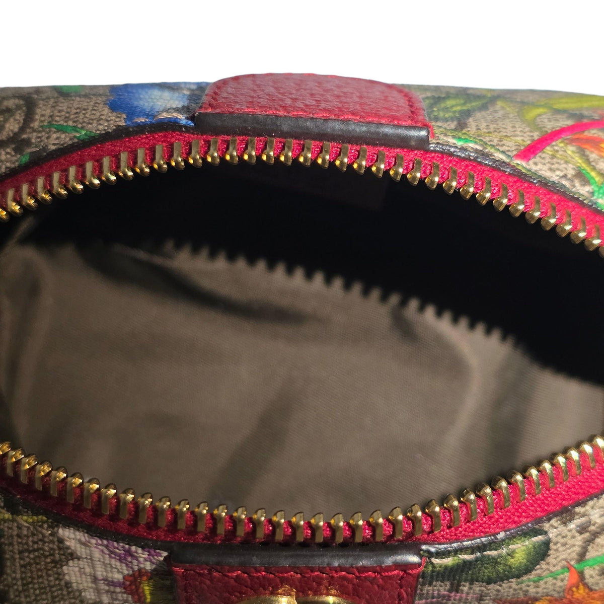 Gucci cream cosmetic case with floral pattern, GG Supreme canvas, and gold hardware.
