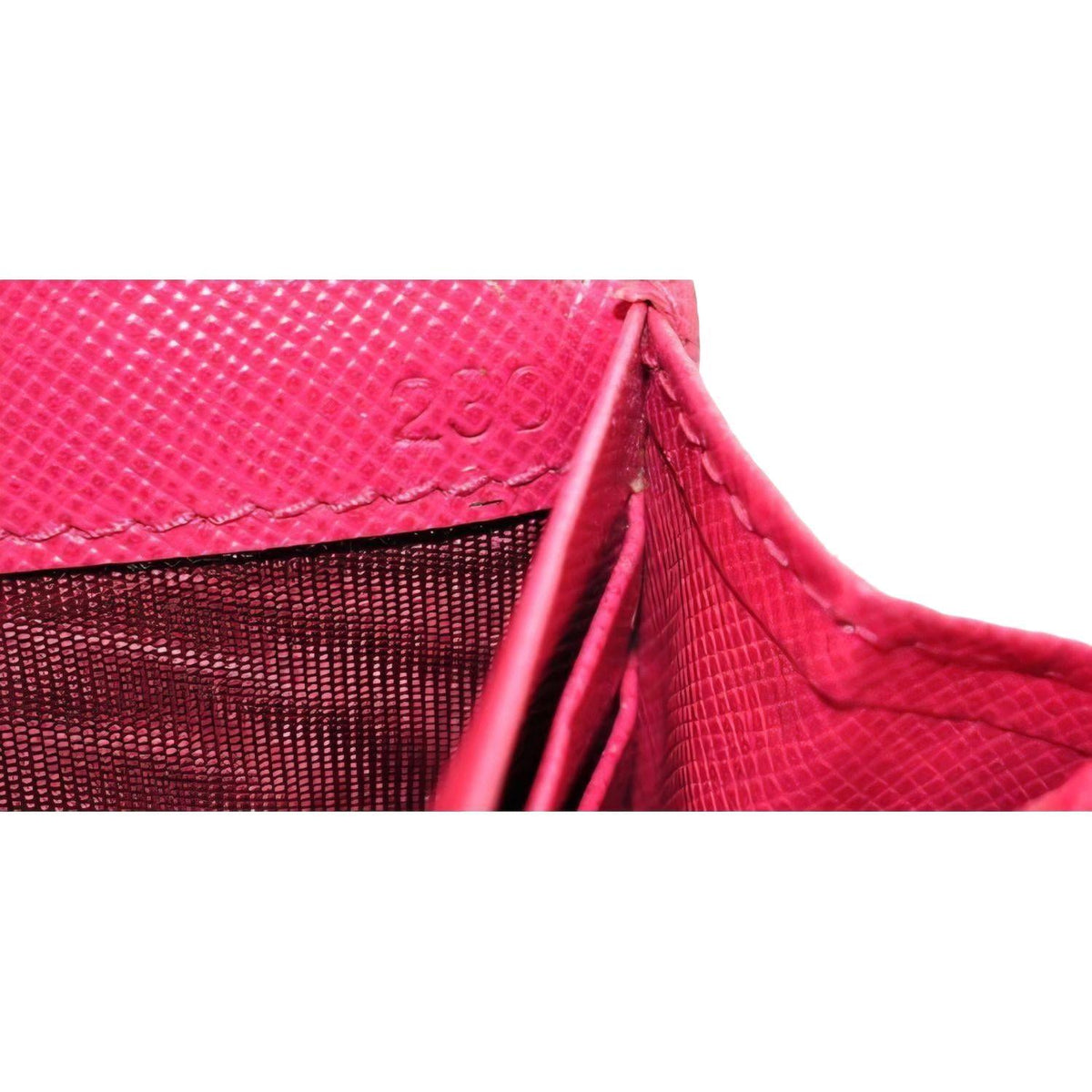 Prada pink leather wallet with logo detail and slim design, perfect for essentials.
