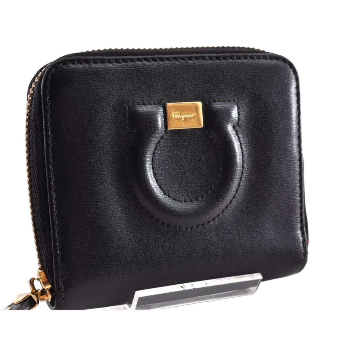 Salvatore Ferragamo cream and pink leather wallet with gold Gancini logo and zip-around design.