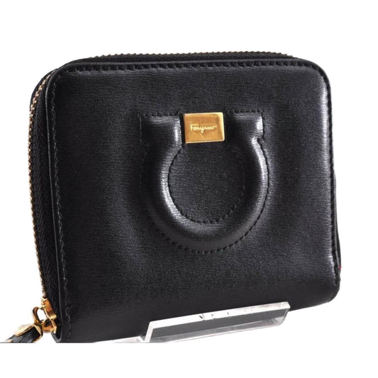 Salvatore Ferragamo cream and pink leather wallet with gold Gancini logo and zip-around design.