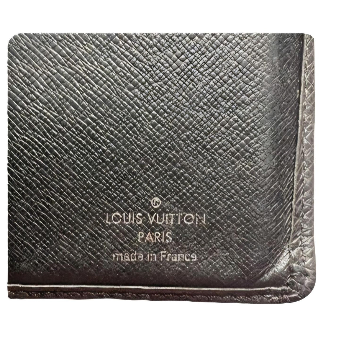 Louis Vuitton brown bi-fold wallet in Taiga leather with logo and multiple card slots.