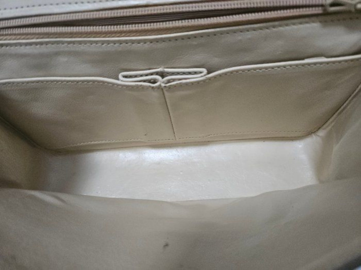 Chanel beige quilted leather flap bag with gold hardware and interlocking CC turn-lock closure.
