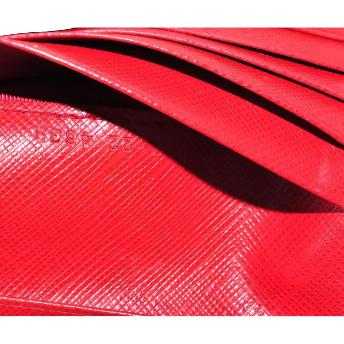 Salvatore Ferragamo red leather wallet with gold hardware and organized interior.