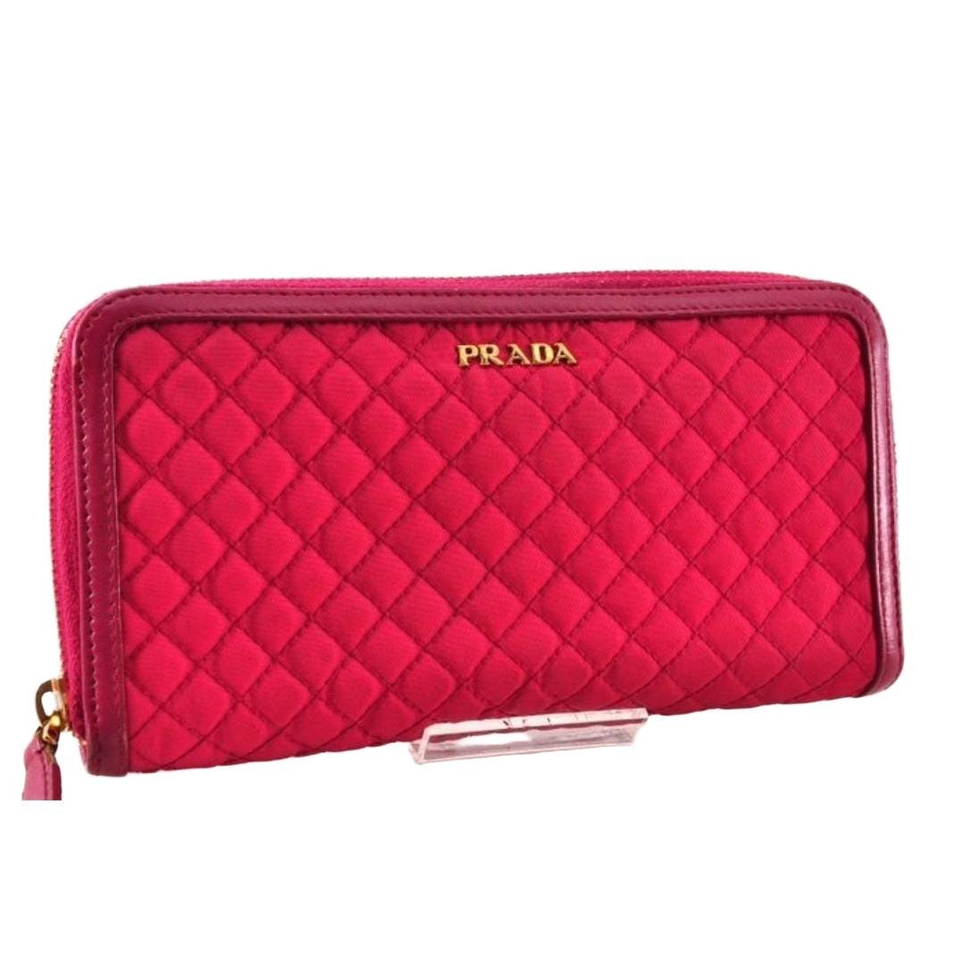 Prada pink nylon and leather zip-around wallet with minimalist design and secure closure.
