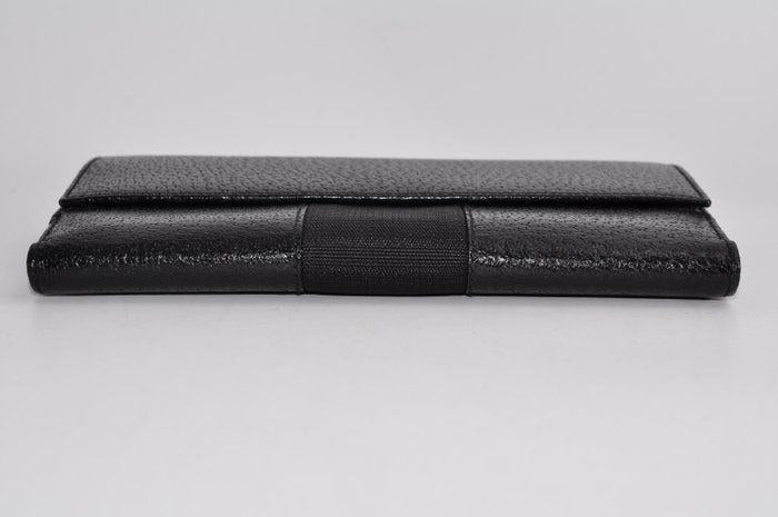 Gucci black leather zip around wallet with gold tone hardware and minimalist design.