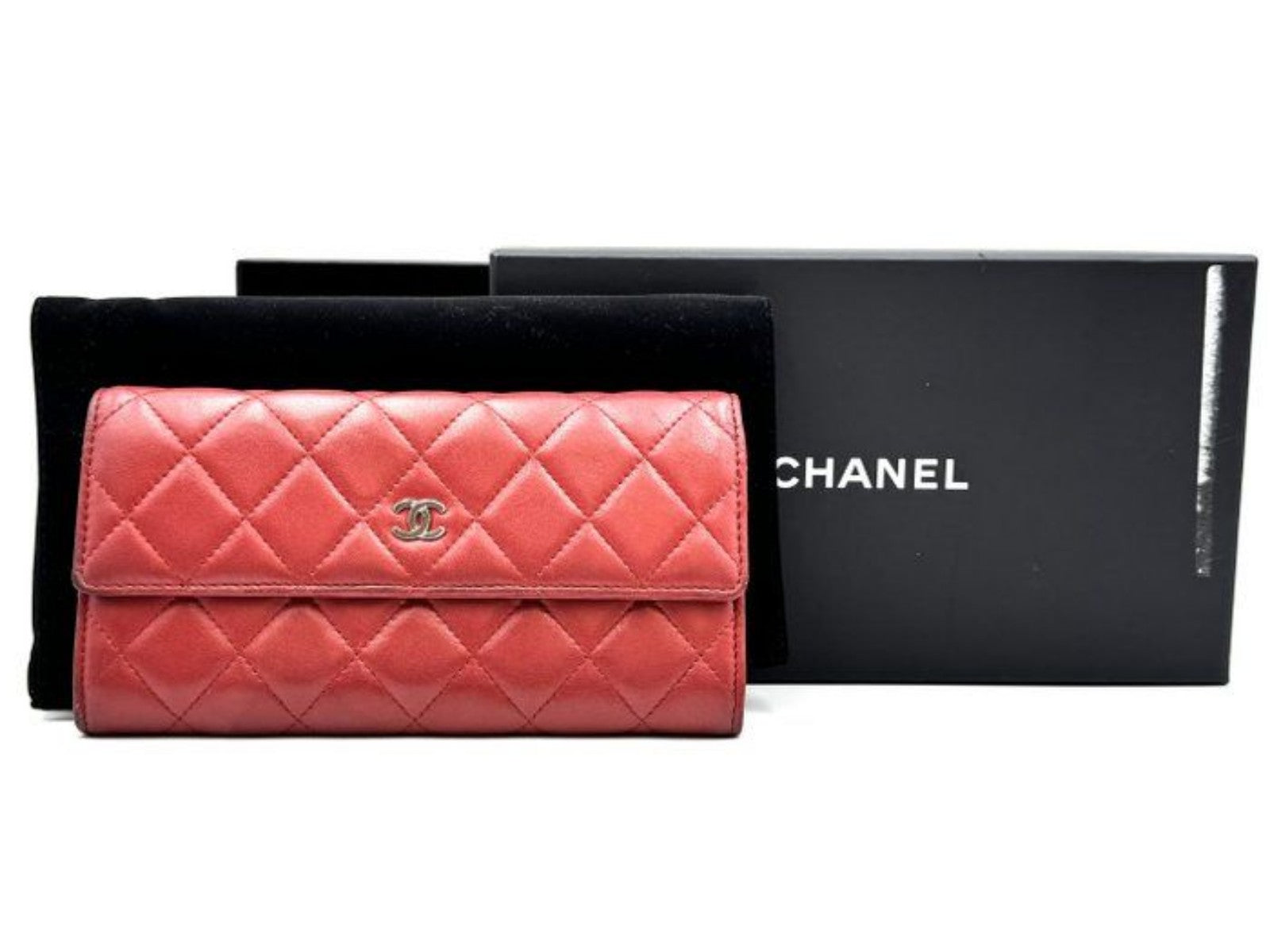 Chanel red quilted leather wallet with CC logo and fabric-lined interior.