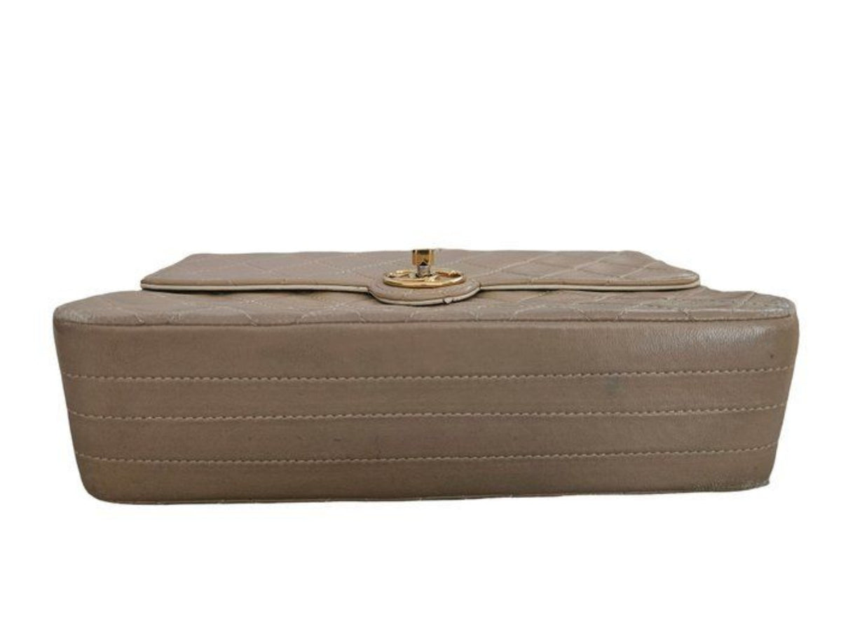 Chanel beige quilted leather flap bag with gold hardware and interlocking CC turn-lock.