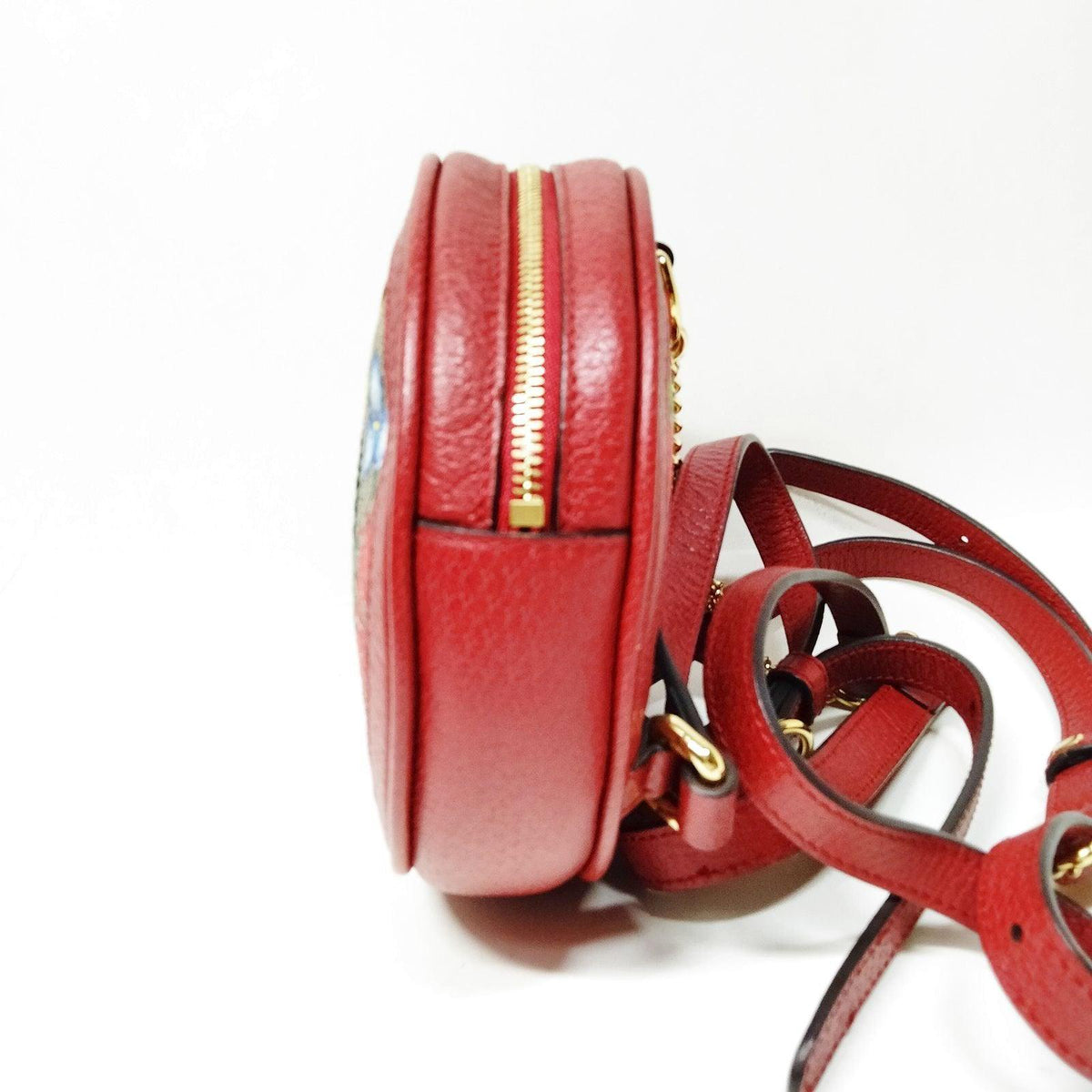 Gucci mini backpack gold GG monogram canvas with floral and butterfly print, interlocking logo.