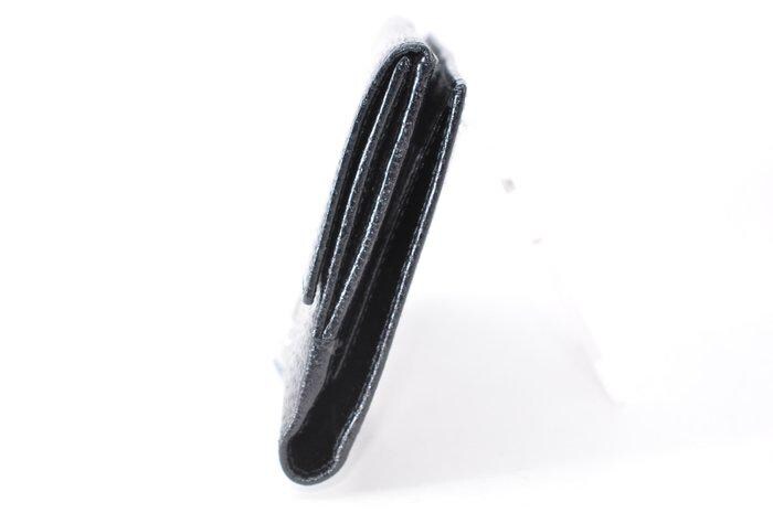 Gucci black leather zip around wallet with gold tone hardware and minimalist design.