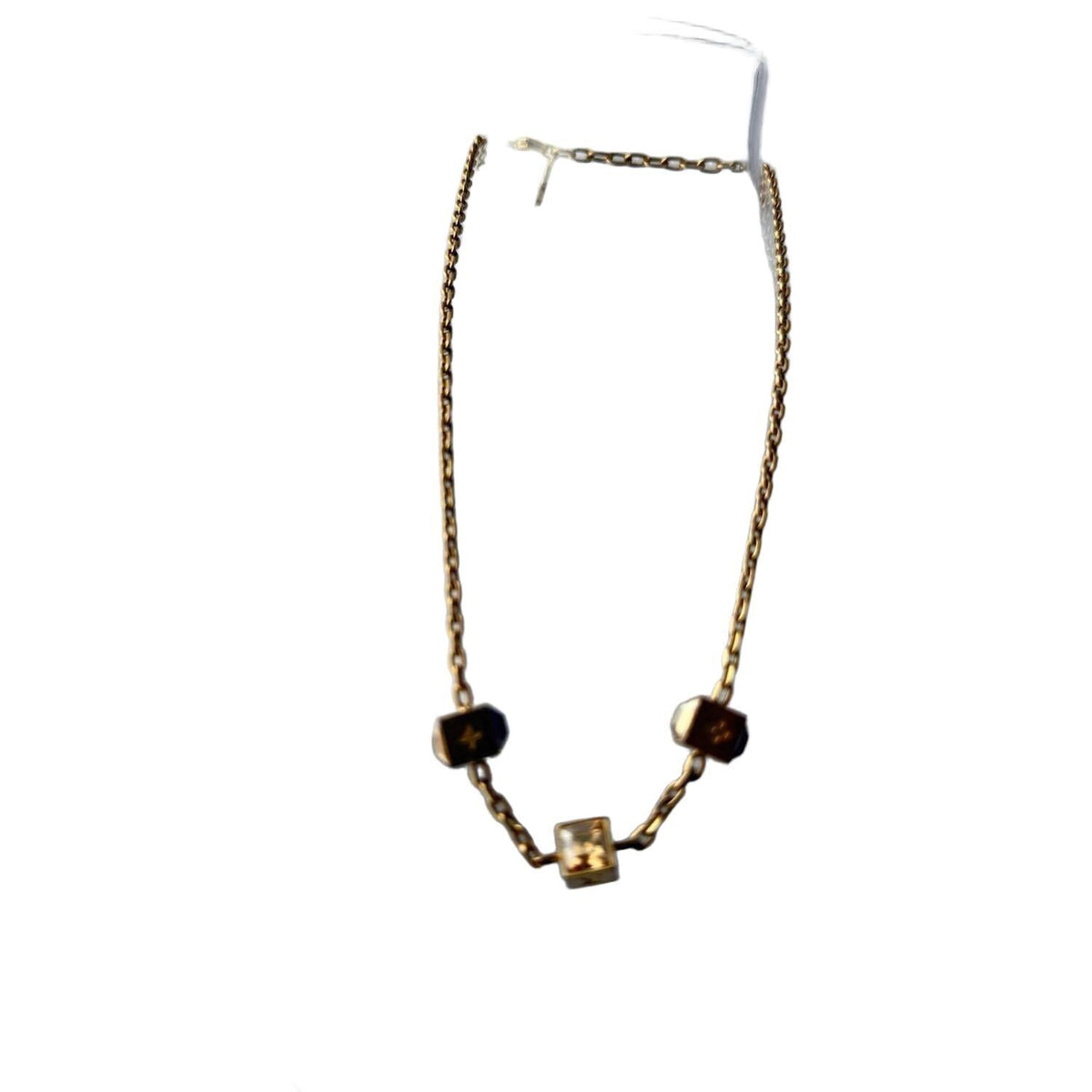 Louis Vuitton gold necklace with monogram dice charms and sparkling crystals.