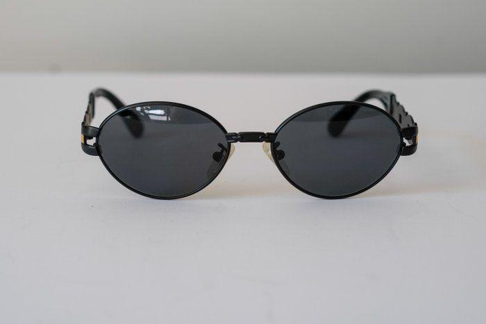 Fendi black and gold sunglasses with logo detail, high-quality plastic and metal frame.
