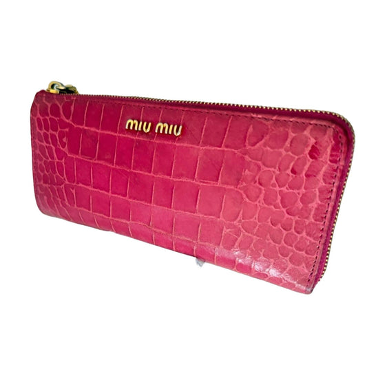 Miu Miu pink leather zip-around wallet with logo detail and soft blush finish.