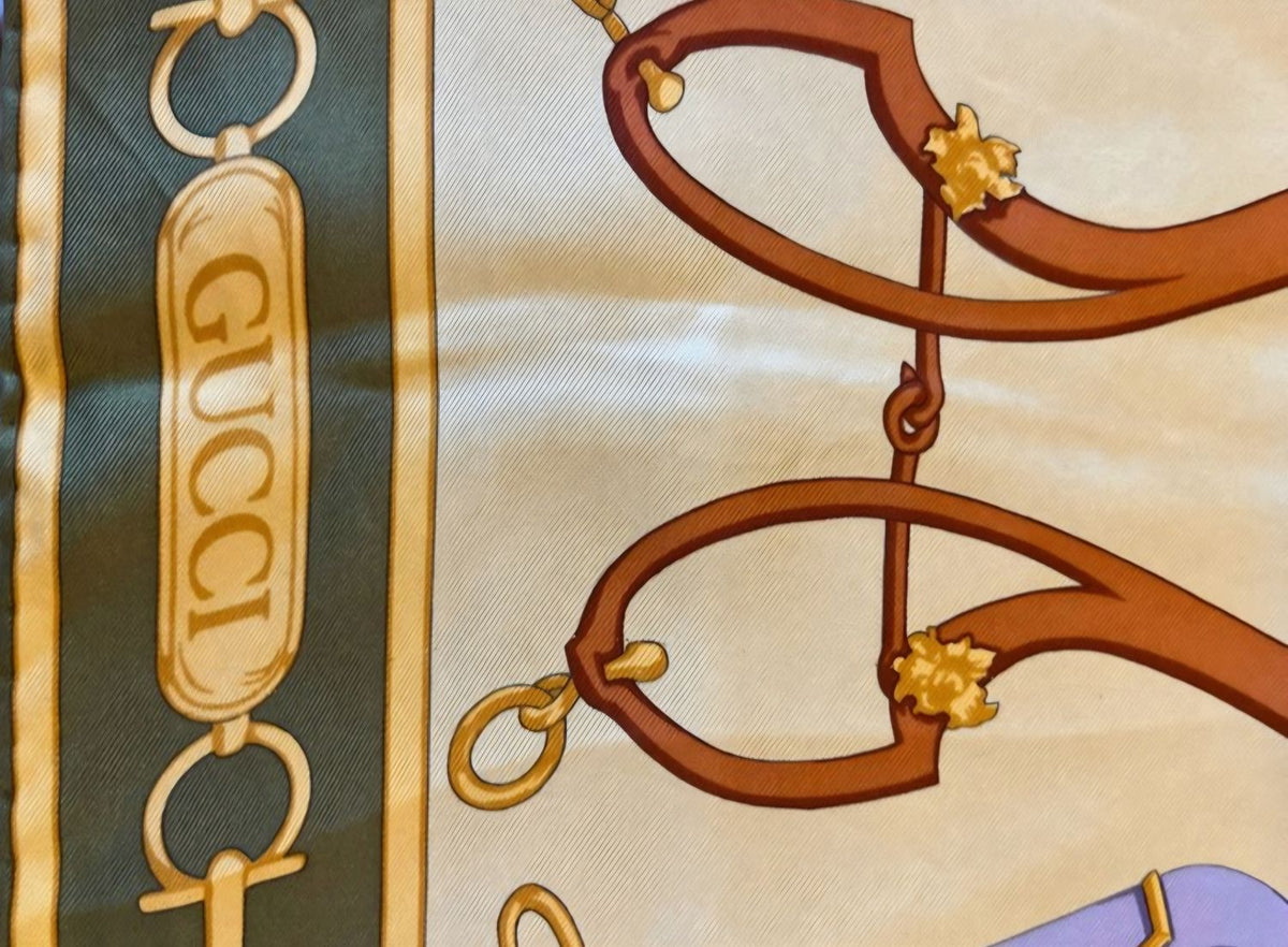 Gucci silk scarf featuring vintage equestrian print in gold, green, and yellow.