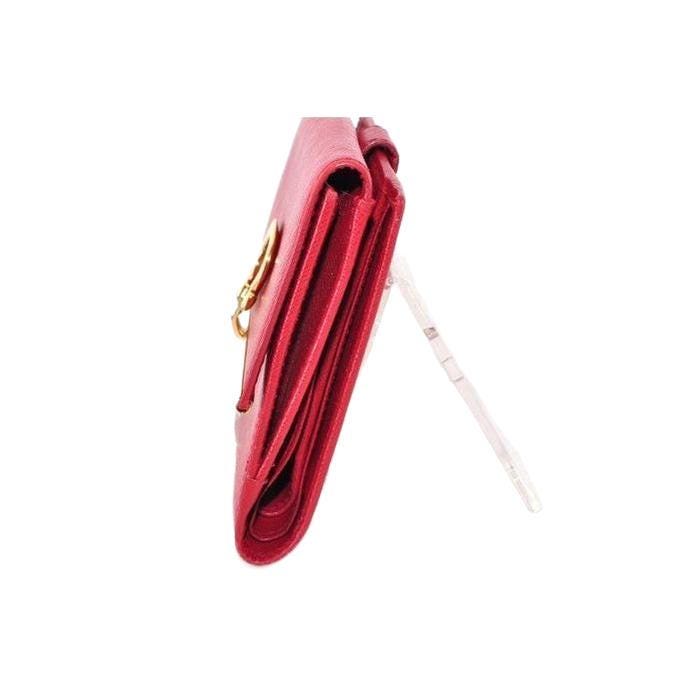 Salvatore Ferragamo red leather wallet with gold hardware and organized interior.