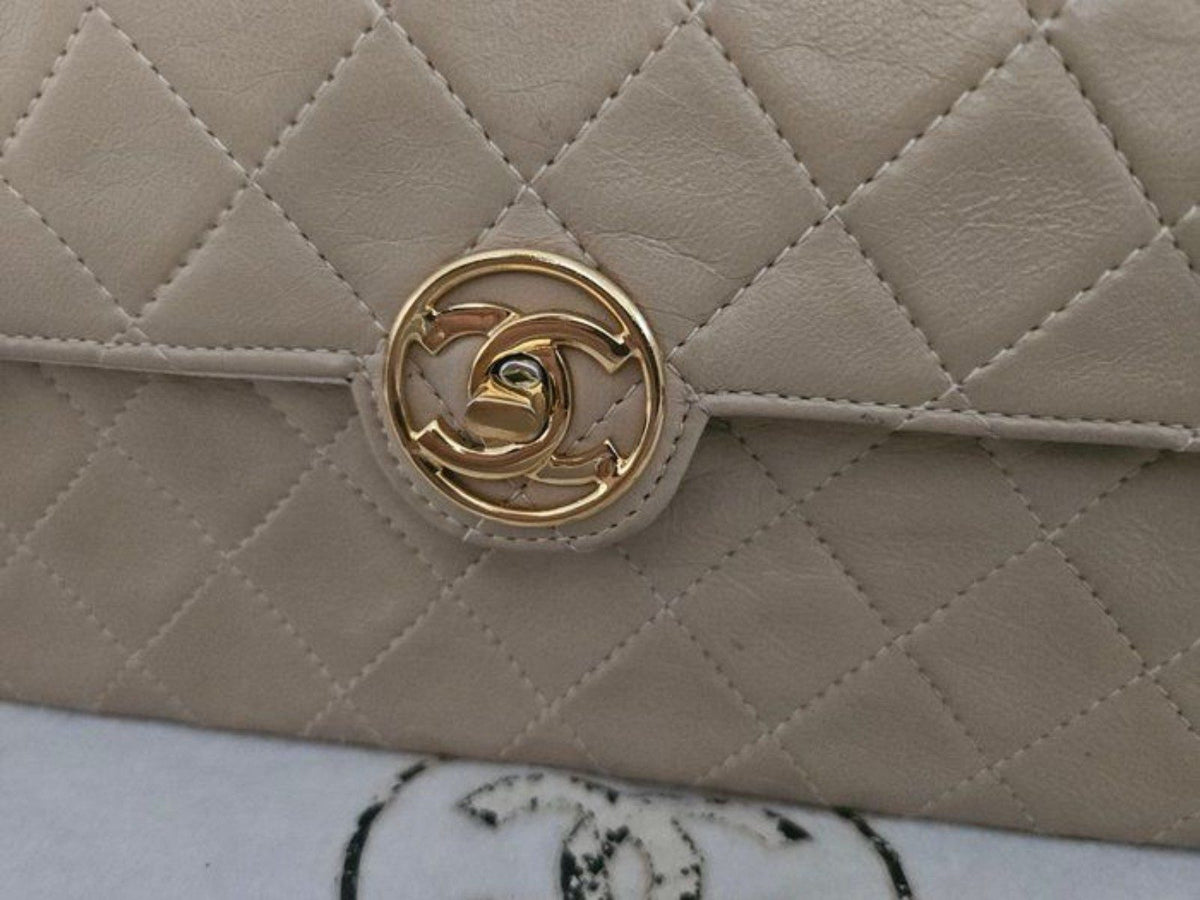 Chanel beige quilted leather flap bag with gold hardware and interlocking CC turn-lock.