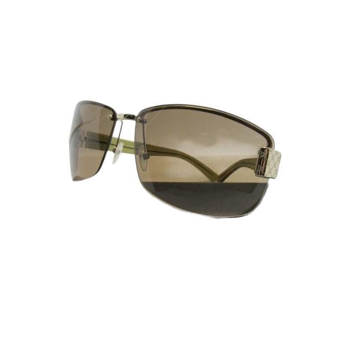 Gucci half-rim wrap sunglasses in green and gold, featuring vintage design and logo.