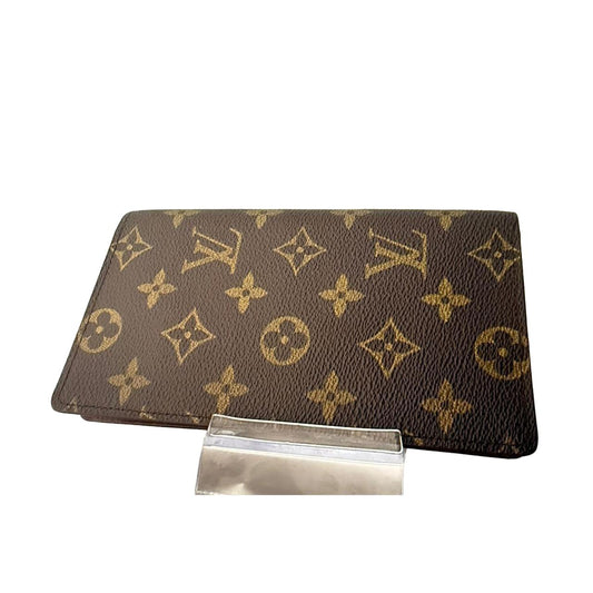 Louis Vuitton brown bifold wallet featuring iconic monogram pattern and coated canvas material.