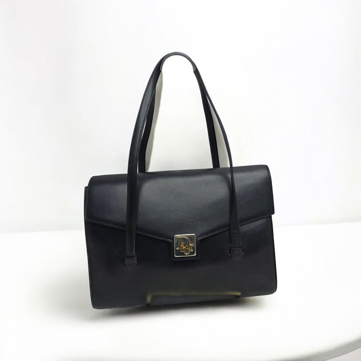Christian Dior black shoulder bag with multi-tone logo clasp and gold-tone hardware.