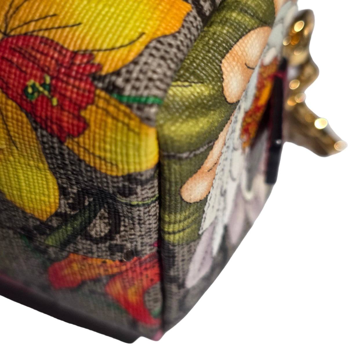 Gucci cream cosmetic case with floral pattern, GG Supreme canvas, and gold hardware.