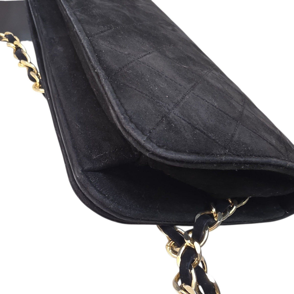 Chanel black quilted suede crossbody bag with gold chain and leather woven strap.