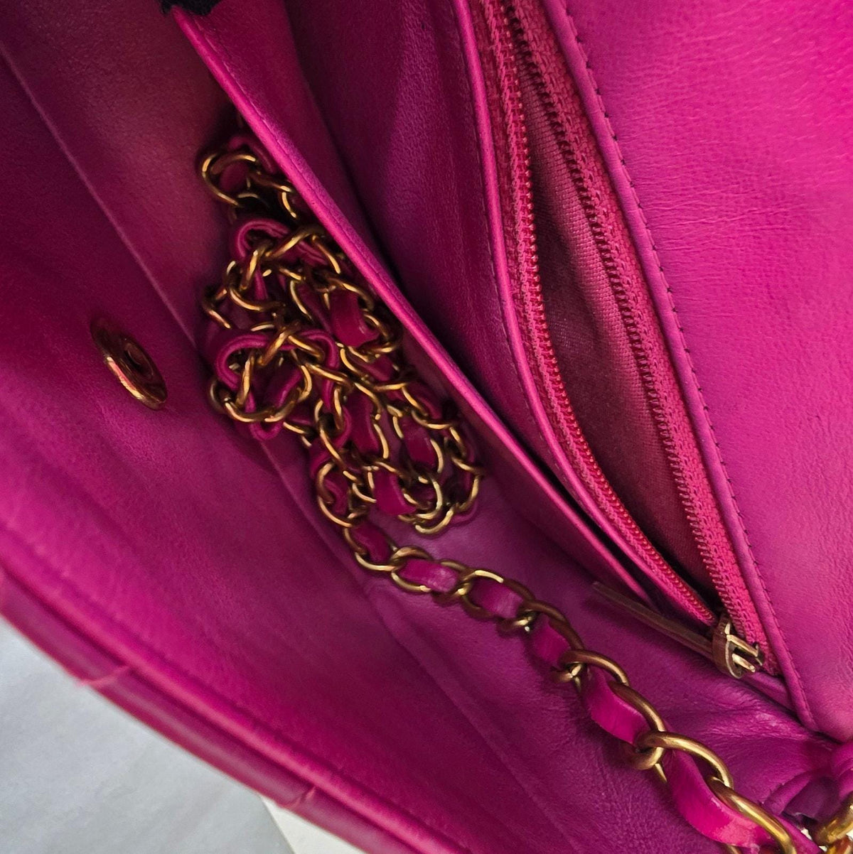 Chanel pink mini messenger bag in chevron leather with gold CC clasp and hardware.