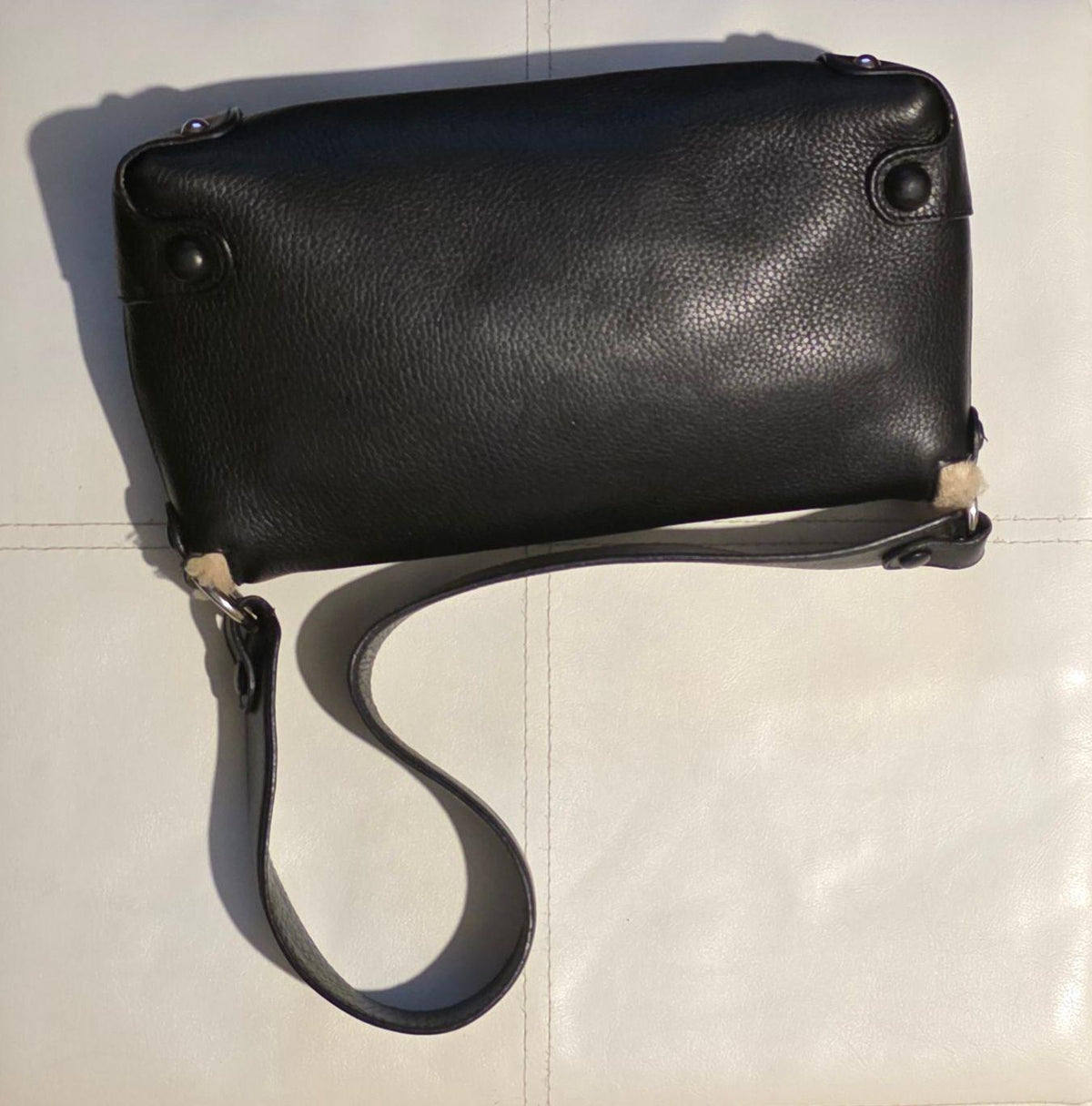 Salvatore Ferragamo black leather purse with shearling trim and Gancini hardware.