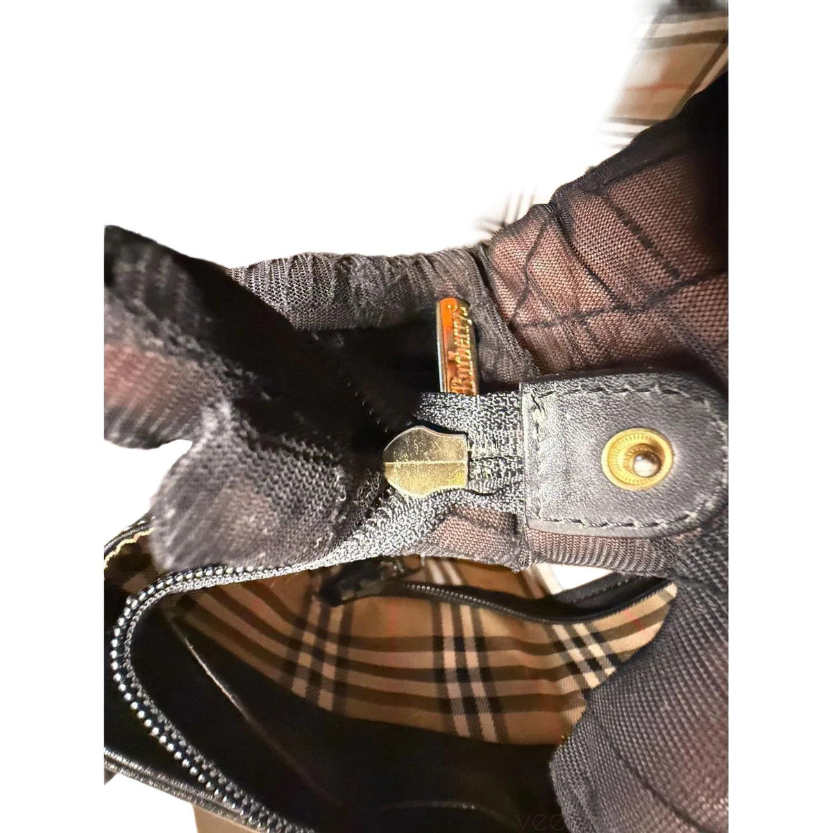 Burberry black tote bag with Nova Check accents and premium calf leather finish.