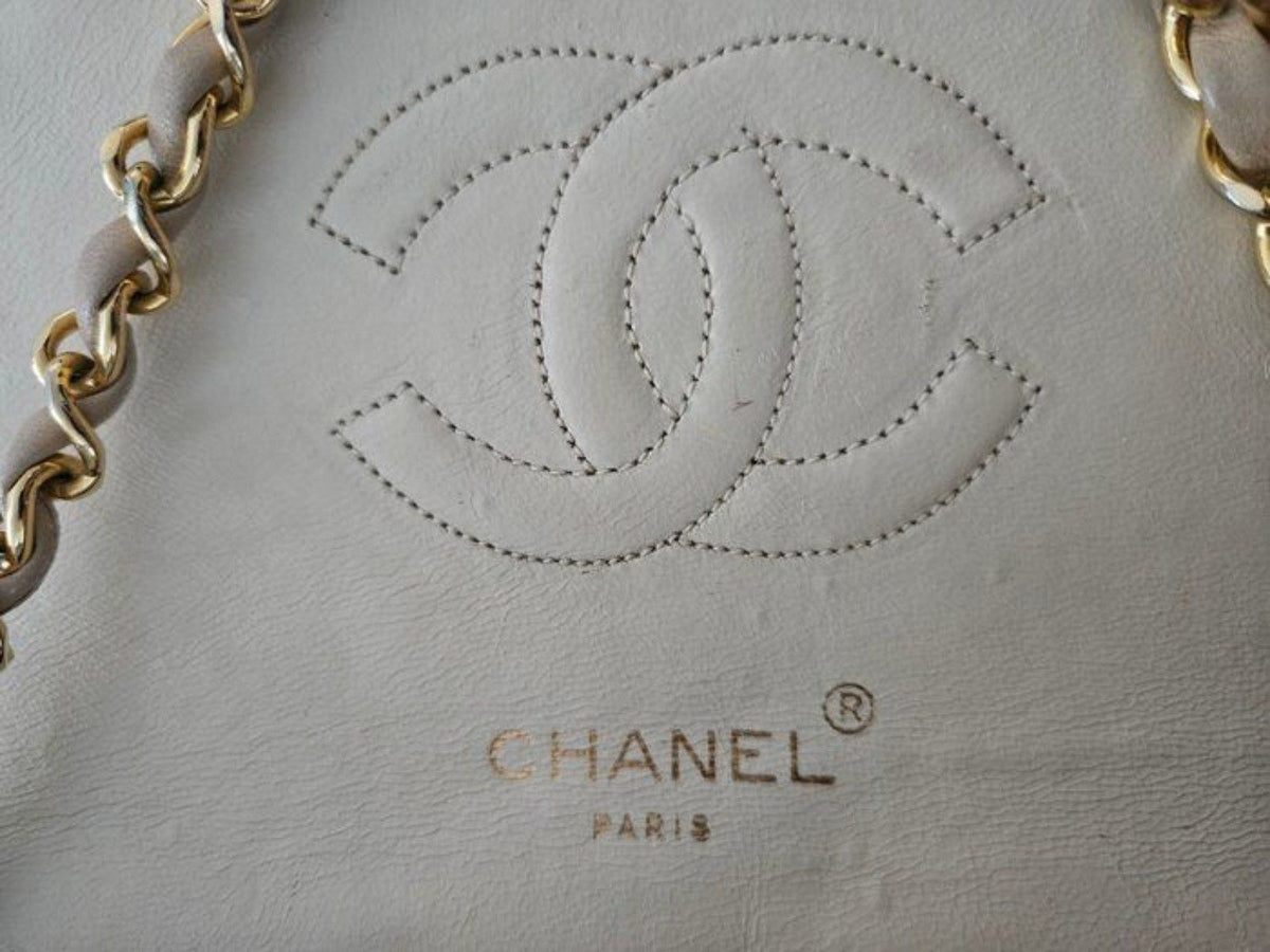 Chanel beige quilted leather flap bag with gold hardware and interlocking CC turn-lock.