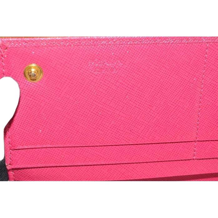 Prada pink leather wallet with logo detail and slim design, perfect for essentials.