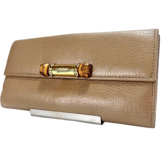 Gucci beige long bifold wallet soft leather with logo detail and organized interior.