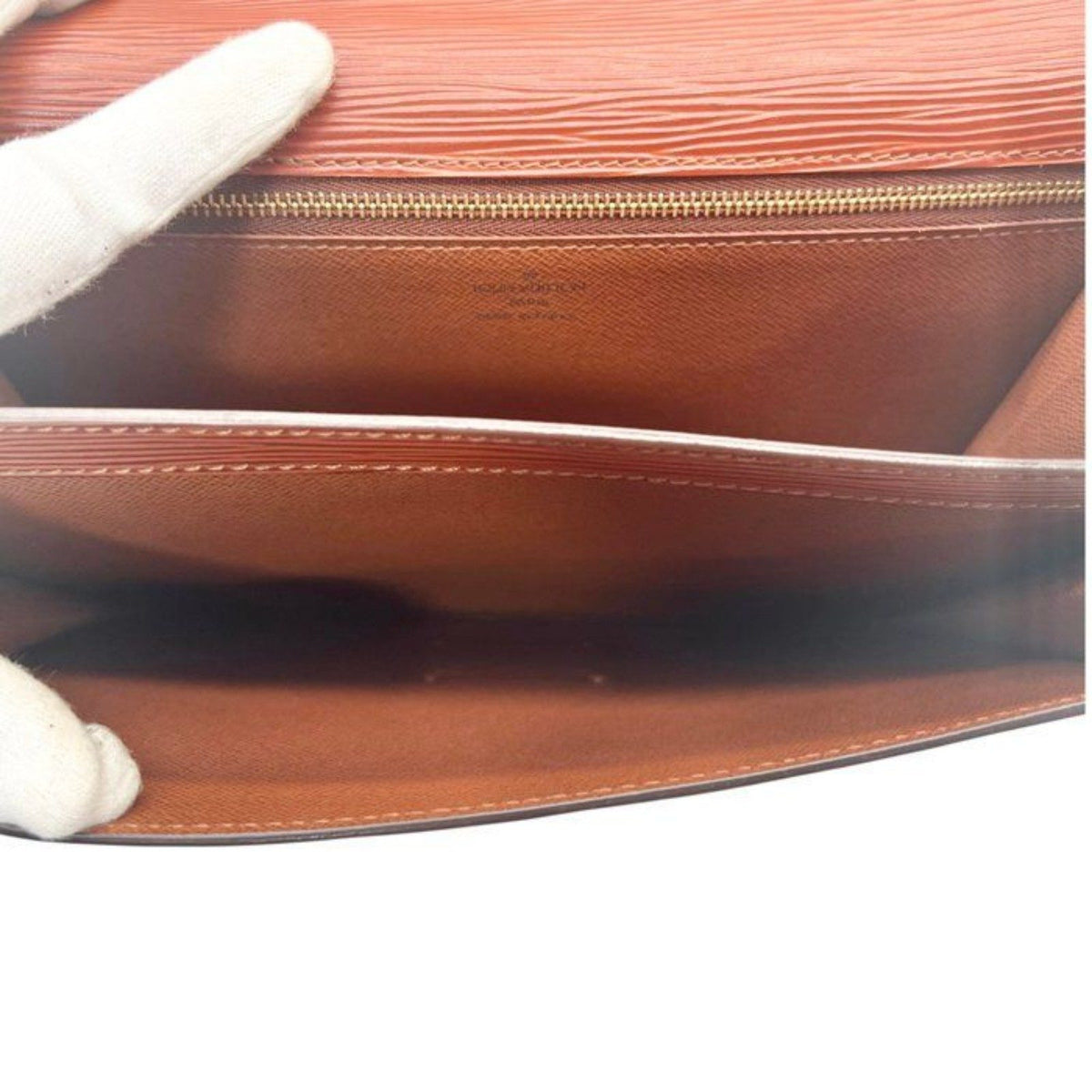 Louis Vuitton brown Epi leather pochette bag with gold hardware and textured finish.